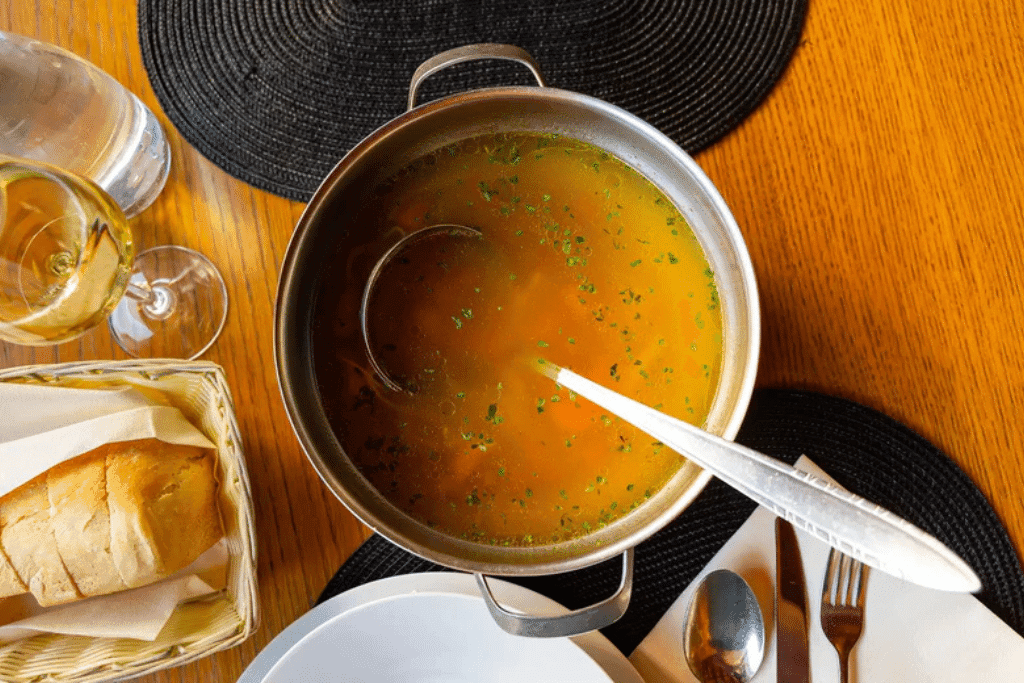 Pot of bone broth on a dining table