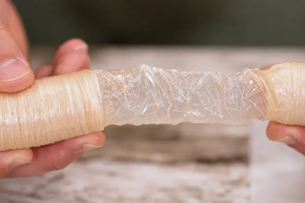 Collagen casing being stretched by hand